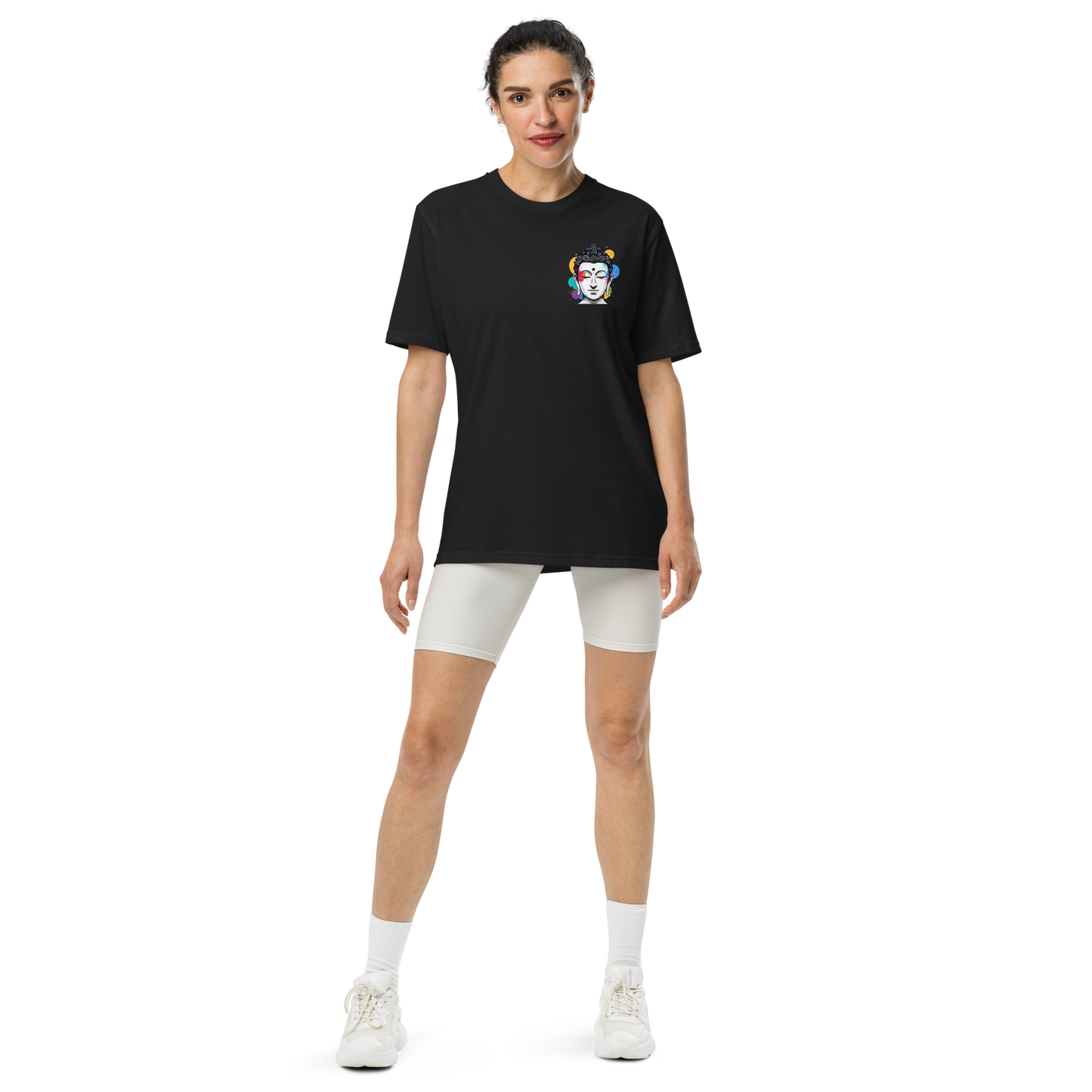 Model wearing a black Under Armour t-shirt featuring a colorful print, paired with white shorts for a sporty look.